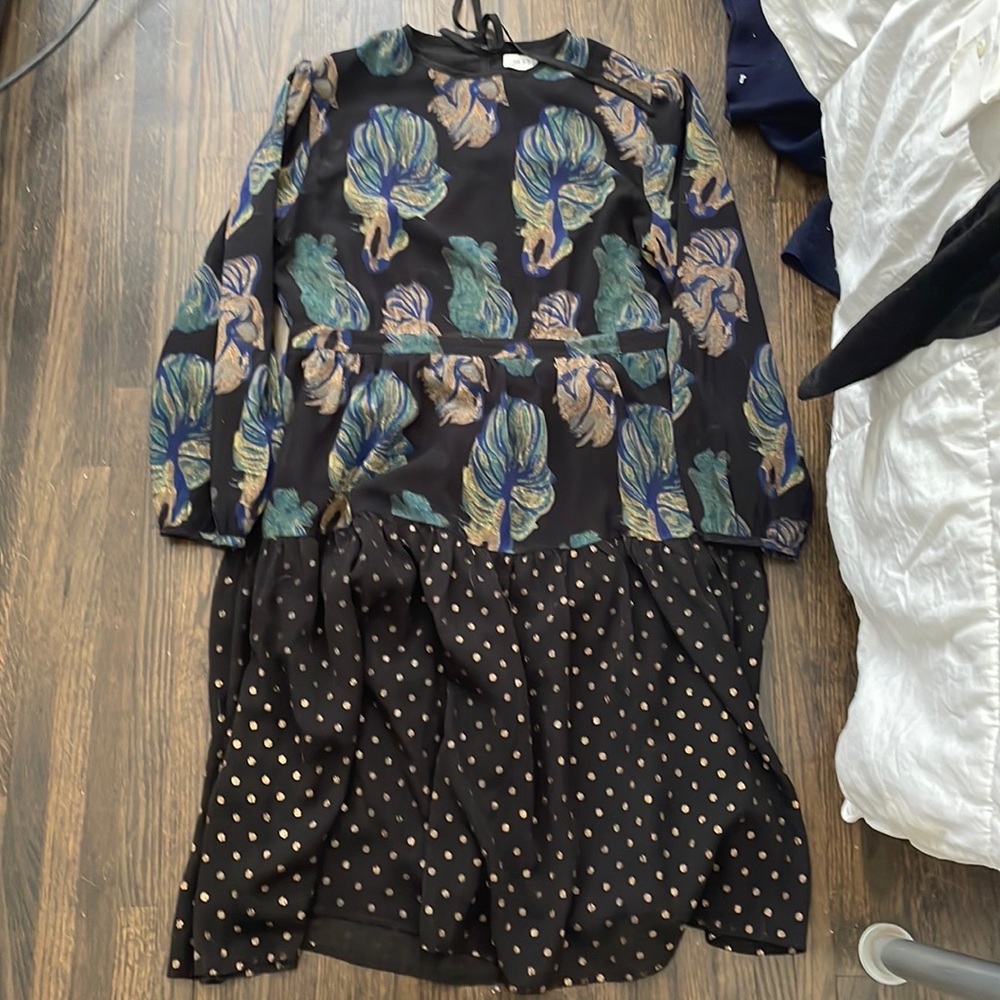 Black dress with green leaves and gold dots on the bottom